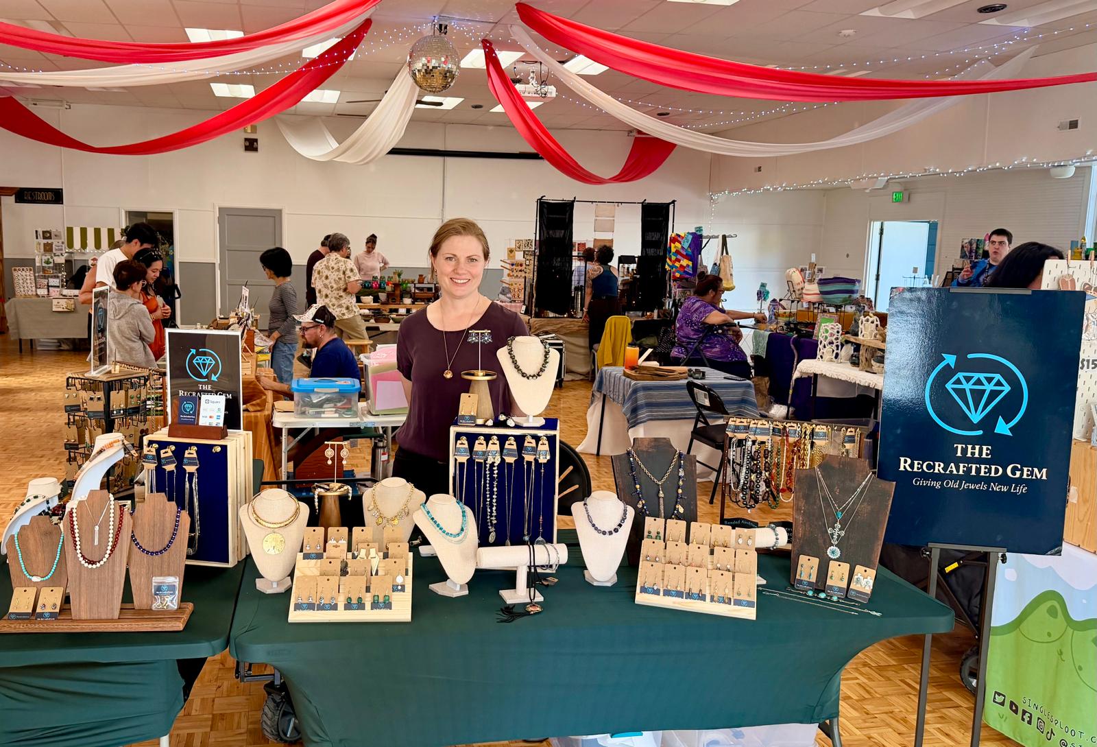 Masina at her ReCrafted Gem booth during an indoor market